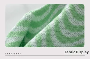 Close-up of soft green and white chevron stripe knit fabric showing detailed texture