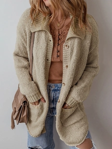 Chunky knit oversized beige cardigan with lapel collar and buttons in a street style look