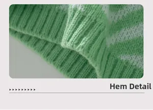 Detail of green and white chevron striped knit sweater showing ribbed hem and texture