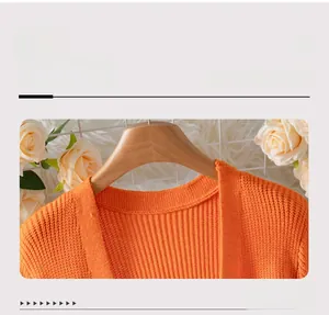 Detail view of V-neck knitting craftsmanship on an orange striped cardigan sweater