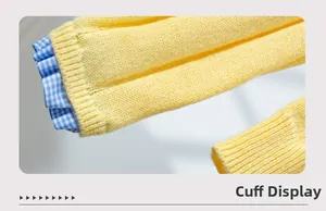 Detail of yellow knit cardigan featuring blue and white plaid ruffle sleeve cuffs