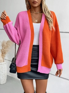 Detail of color-block knit cardigan in pink and orange with relaxed drop shoulder fit