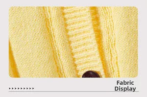 Macro detail of yellow knit fabric showing thick texture and dark round button