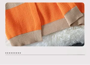 Detail shot of the orange and beige striped rib-knit hem on the longline cardigan