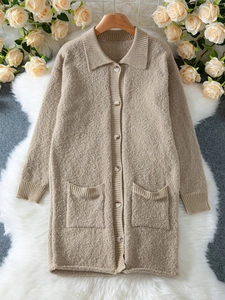 Detailed texture of beige knit cardigan featuring a lapel collar and button closure