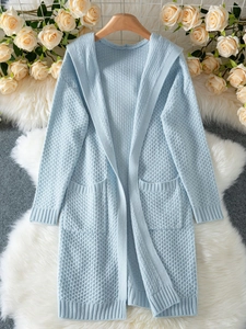 Close-up of light blue hooded knit cardigan with honeycomb texture and front pockets