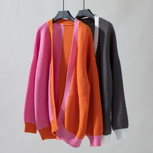 Detailed view of color-block knit cardigan texture and ribbed cuff craftsmanship