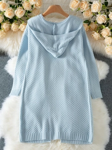 Detail of light blue waffle knit hooded cardigan with ribbed cuffs on wooden hanger