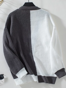 Close-up of knit texture and ribbed cuffs on the black and white patchwork sweater