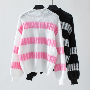 Detail of distressed striped knit sweater texture with frayed edges and ribbed cuffs