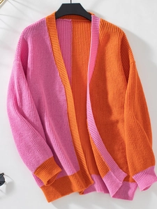 Detail of chunky knit texture on pink and orange color-block long sleeve cardigan