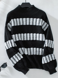 Detail of black and white striped knit sweater featuring unique fringed texture details
