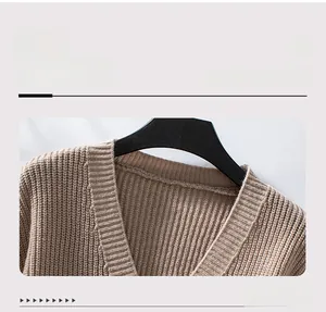 Detailed macro view of the khaki knitted cardigan featuring a V-neck and thick ribbed texture
