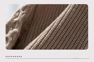 Macro shot of chunky knit fabric texture showing cable stitch and honeycomb patterns