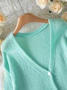 Women's V-neck mint green fuzzy knit cardigan with single white button closure
