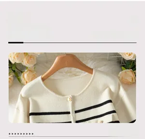 Close-up of the round neckline and gold buttons on the striped knit cardigan