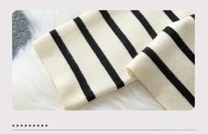 Detailed macro view of black and white striped knit cuffs on a long sleeve cardigan