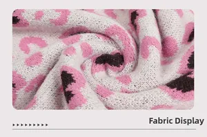 Close-up of soft pink and black leopard print knit fabric with a plush texture