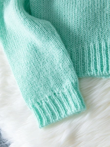 Chunky mint green V-neck knit cardigan with button closure and soft mohair texture