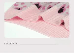 Detailed view of pink ribbed cuffs and leopard print knit fabric texture