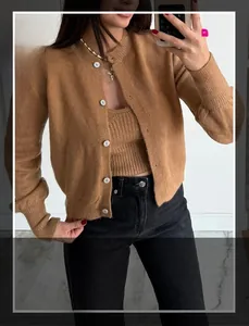 Detail of camel knit cardigan set with white buttons and matching tube top sweater