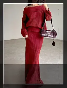 Detail view of deep red knit two-piece set showing textured ribbed fabric and off-shoulder cut