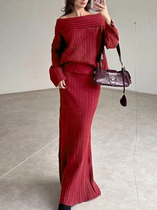 Detail of burgundy ribbed knit set featuring off-shoulder sweater and high waist maxi skirt