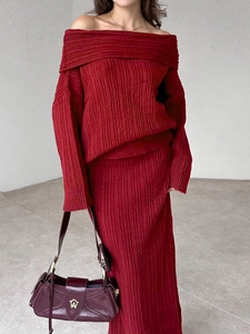 Detail of burgundy off-shoulder knit sweater and ribbed midi skirt set for women
