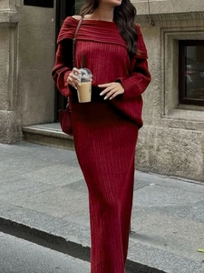 Detailed view of elegant burgundy pleated knit two-piece set with off-shoulder design