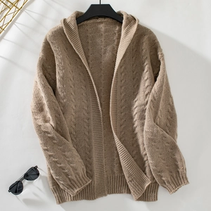 Détails de maille d'un cardigan marron à capuche surdimensionné avec motif torsadé