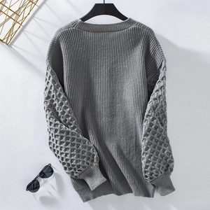 Detailed view of grey knit cardigan showing 3D honeycomb sleeve texture and ribbed body