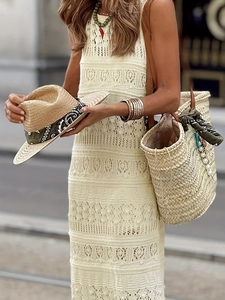 Elegant beige sleeveless crochet hollow out knit dress with a bohemian vacation style