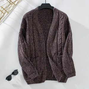Detailed knit texture of dark brown cable knit cardigan with vintage pocket details