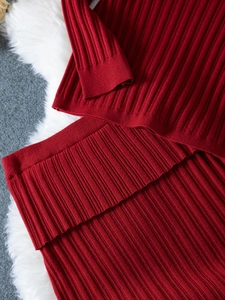 Close-up of dark red ribbed knit fabric texture and high-quality edge stitching details