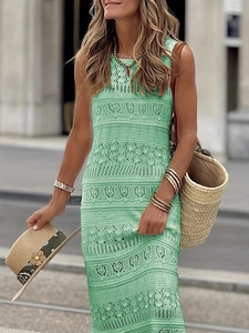 Detail view of mint green sleeveless crochet dress with intricate hollow-out patterns