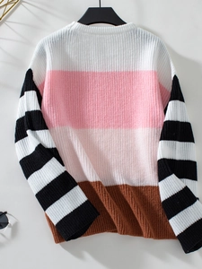 Detailed texture of women's round neck knit sweater with color-blocked striped patterns