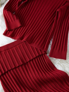 Macro detail of red ribbed knit texture and soft fabric of this elegant two-piece set
