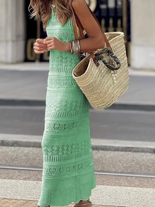 Detail of green crochet hollow-out dress with intricate knit patterns and bohemian style