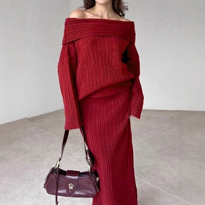 Elegant burgundy knit two-piece set featuring off-shoulder sweater and ribbed midi skirt