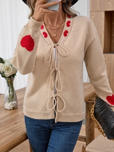 Chic beige knit cardigan with red heart patterns and front tie ribbons for women