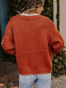 Back view of a casual orange floral jacquard knit cardigan for women outdoors