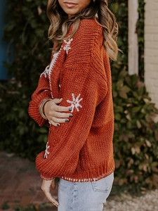 Orange chunky knit cardigan with white snowflake pattern sleeves for autumn winter fashion