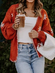 Orange long-sleeved knit cardigan with white floral embroidery and contrast stitching details