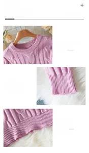 Detail view of pink cable knit sweater featuring round neck, ribbed cuffs and soft fabric