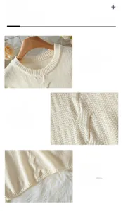 Detail showing the cable knit texture, ribbed neckline, and soft beige fabric of the sweater