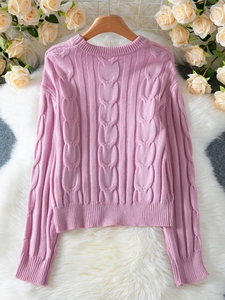 Cozy pink cable knit sweater for women with ribbed cuffs and relaxed spring style