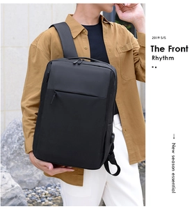 Close-up of black commuter backpack with external USB charging port in outdoor use