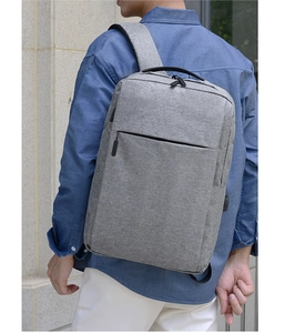 Detailed view of grey laptop backpack with integrated USB port and ergonomic straps