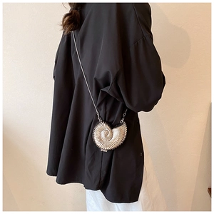 Detailed view of silver nautilus shell shaped chain crossbody bag with metallic finish