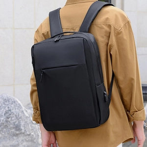 Minimalist black travel backpack with USB charging port and ergonomic sponge straps